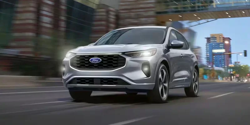 A 2024 Ford Escape with its headlights on