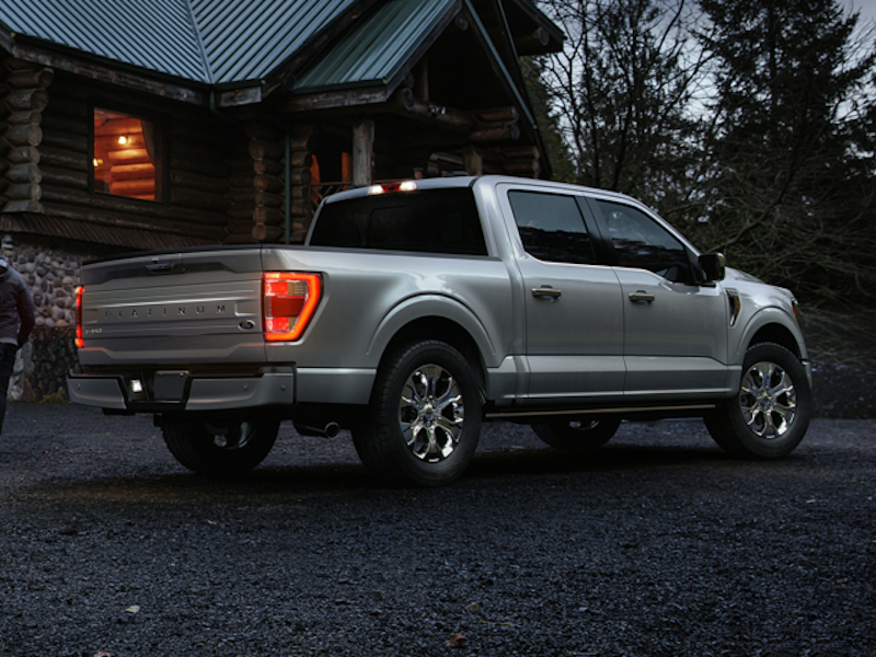 The Ford F-150 sitting at a log cabin