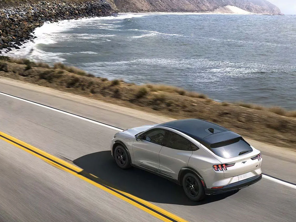A 2024 Ford Mustang Mach-E driving on the highway