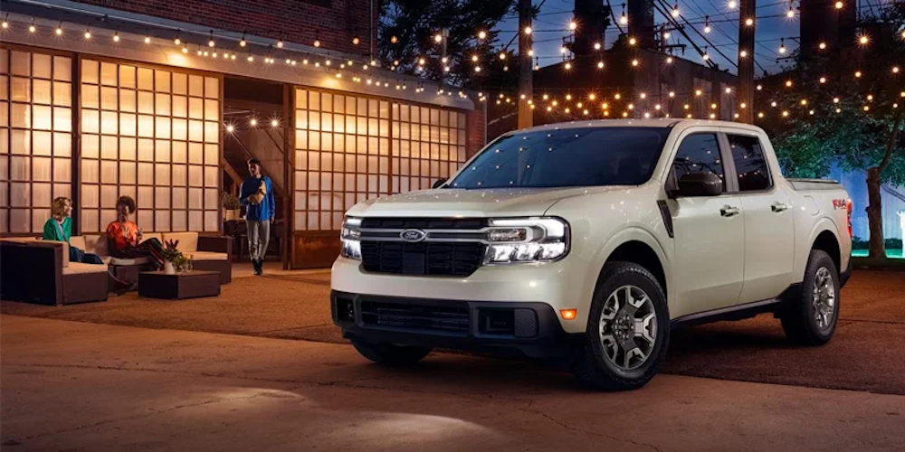 The 2024 Ford Maverick sitting outside of an urban home.