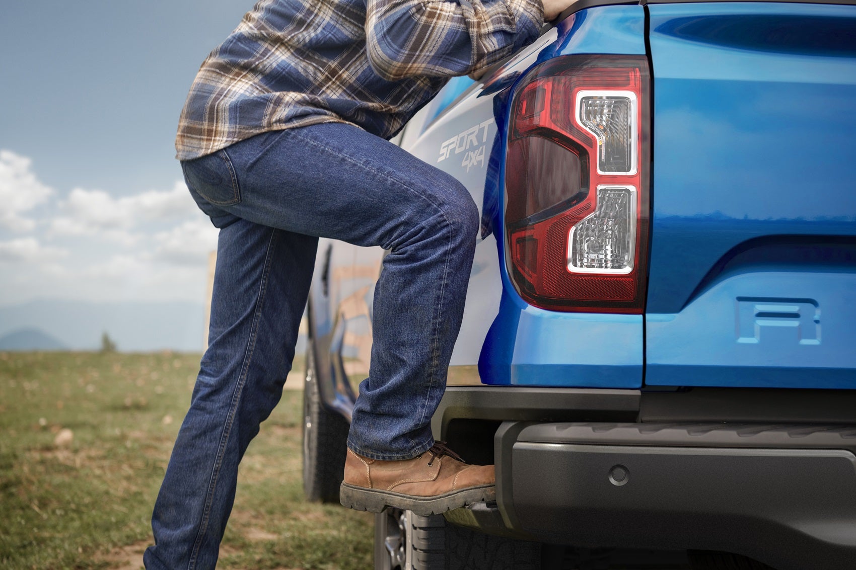 Close-up of man getting up to look at the truckbed